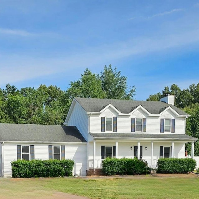 2746 Field Ct, Woodlawn, TN 37191 - view of front facade featuring a chimney, a front yard, and covered porch
