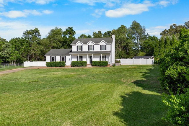 2746 Field Ct, Woodlawn, TN 37191 - view of front of house featuring a chimney, covered porch, and view of scattered trees