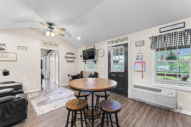 4496 Jonesville Rd, Clarkrange, TN 38553 - dining room with an AC wall unit, ceiling fan, wood finished floors, baseboards, and lofted ceiling