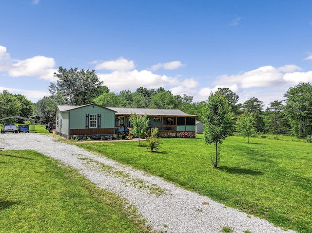 4496 Jonesville Rd, Clarkrange, TN 38553 - view of front facade featuring driveway, a carport, a front yard, metal roof, and view of scattered trees