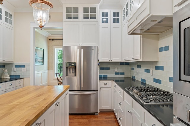 2111 Lovelace Ln, Murfreesboro, TN 37130 - kitchen with appliances with stainless steel finishes, butcher block countertops, crown molding, white cabinets, and under cabinet range hood