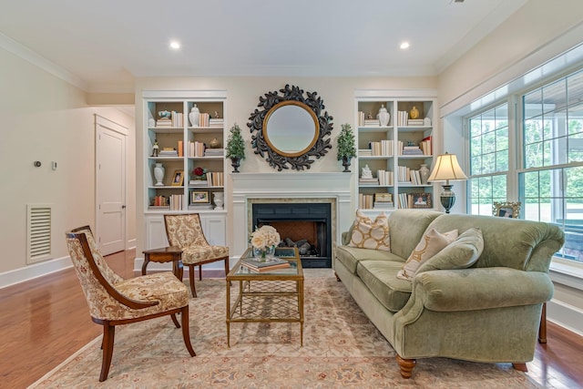 2111 Lovelace Ln, Murfreesboro, TN 37130 - living room with healthy amount of natural light, crown molding, wood finished floors, a fireplace, and built in shelves
