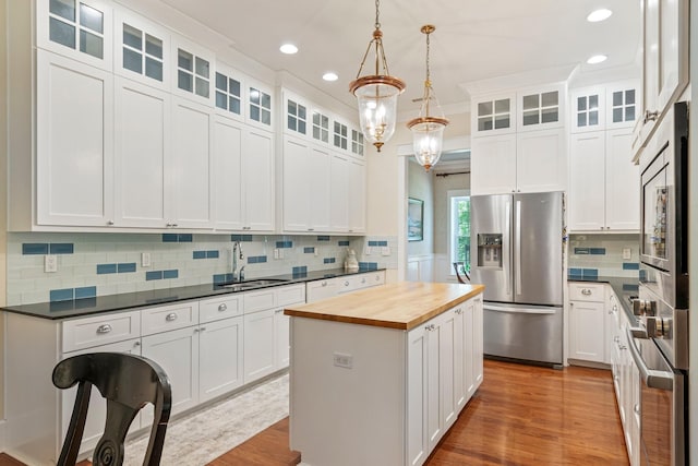 2111 Lovelace Ln, Murfreesboro, TN 37130 - kitchen featuring appliances with stainless steel finishes, wooden counters, a sink, a kitchen island, and wood finished floors