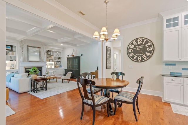 2111 Lovelace Ln, Murfreesboro, TN 37130 - dining room with a chandelier, light wood finished floors, built in shelves, beam ceiling, and baseboards