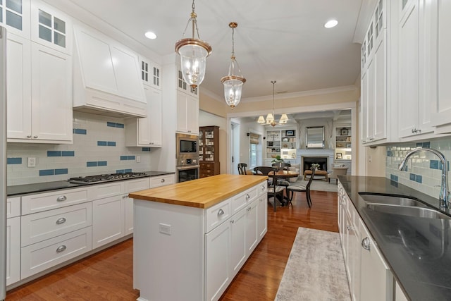 2111 Lovelace Ln, Murfreesboro, TN 37130 - kitchen featuring butcher block countertops, appliances with stainless steel finishes, a sink, ornamental molding, and a chandelier