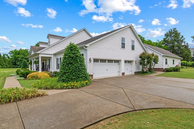 2111 Lovelace Ln, Murfreesboro, TN 37130 - view of property exterior with concrete driveway, a lawn, an attached garage, a porch, and roof with shingles