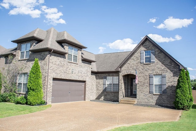 112 Read Tavern Rd, Hendersonville, TN 37075 - french country home featuring driveway, an attached garage, brick siding, and a shingled roof