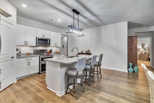 211 Addison Ave, Chapel Hill, TN 37034 - kitchen featuring stainless steel appliances, a sink, light wood-type flooring, white cabinets, and recessed lighting