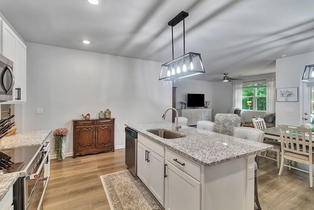 211 Addison Ave, Chapel Hill, TN 37034 - kitchen featuring a sink, ceiling fan, stainless steel appliances, white cabinets, and light wood-style floors