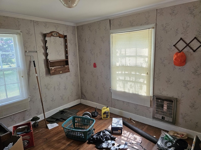 221 Franklin St, Cowan, TN 37318 - empty room featuring wood finished floors, plenty of natural light, heating unit, and ornamental molding