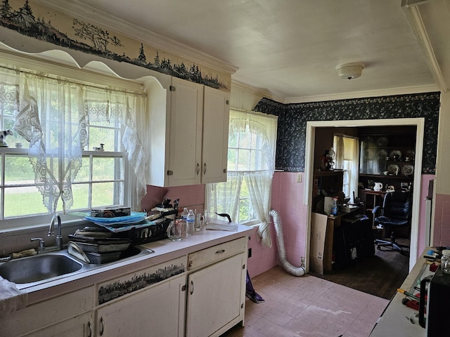 221 Franklin St, Cowan, TN 37318 - kitchen featuring crown molding, healthy amount of natural light, white cabinets, wallpapered walls, and a sink