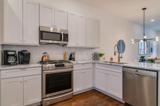 2001 Convent Pl Unit 7, Nashville, TN 37212 - kitchen featuring stainless steel appliances, a sink, a chandelier, and tasteful backsplash