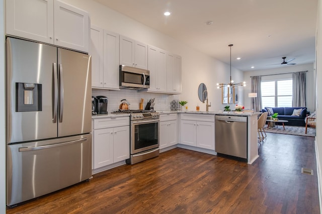 2001 Convent Pl Unit 7, Nashville, TN 37212 - kitchen with stainless steel appliances, open floor plan, a peninsula, dark wood-type flooring, and decorative backsplash