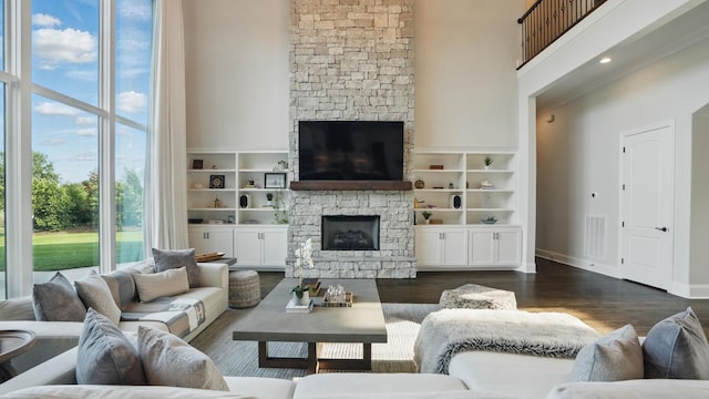 4740 Edwardian Trce, Franklin, TN 37067 - living area with a stone fireplace, a high ceiling, dark wood finished floors, and baseboards