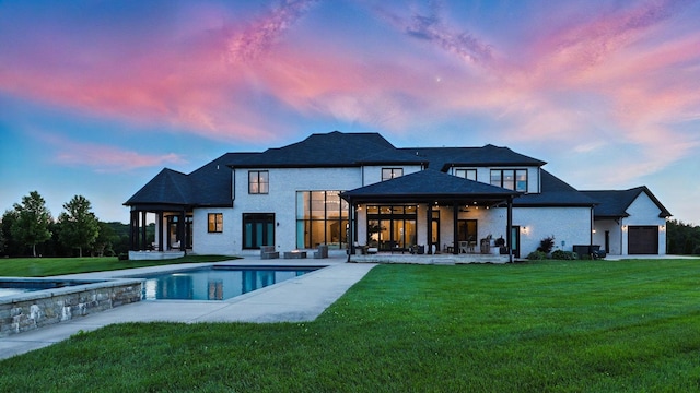 4740 Edwardian Trce, Franklin, TN 37067 - back of property at dusk with a yard, an outdoor pool, and a patio area