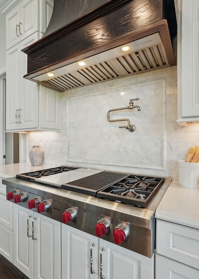4740 Edwardian Trce, Franklin, TN 37067 - kitchen with range hood, backsplash, stainless steel gas stovetop, light countertops, and white cabinets