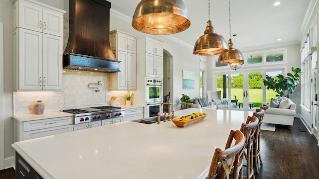 4740 Edwardian Trce, Franklin, TN 37067 - kitchen with premium range hood, stainless steel appliances, ornamental molding, open floor plan, and light countertops