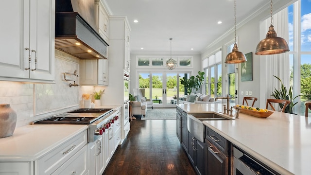 4740 Edwardian Trce, Franklin, TN 37067 - kitchen with custom range hood, stainless steel gas cooktop, white cabinets, light countertops, and dark wood finished floors