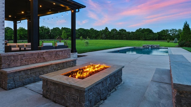 4740 Edwardian Trce, Franklin, TN 37067 - pool at dusk featuring an outdoor fire pit, a patio area, a lawn, and an outdoor pool