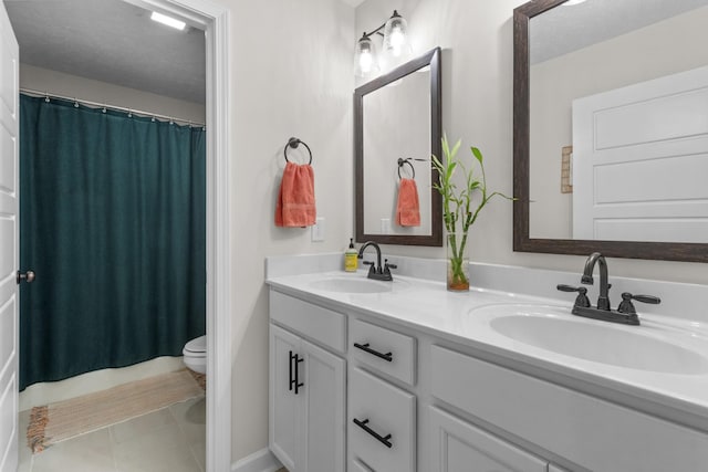 1013 Brightwood Ct, Clarksville, TN 37043 - full bath featuring toilet, double vanity, tile patterned flooring, and a shower with shower curtain