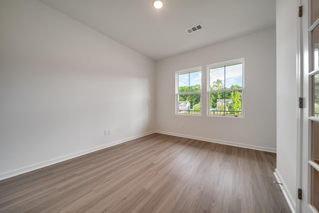 316 Deacon Ln, White House, TN 37188 - empty room featuring vaulted ceiling, wood finished floors, and baseboards