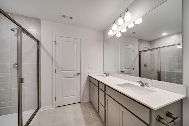 316 Deacon Ln, White House, TN 37188 - full bathroom featuring double vanity, a stall shower, tile patterned floors, and baseboards