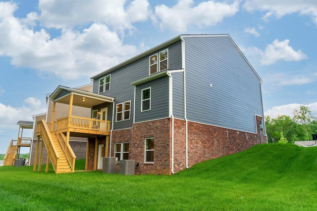 316 Deacon Ln, White House, TN 37188 - back of property featuring brick siding, stairs, a yard, and a wooden deck