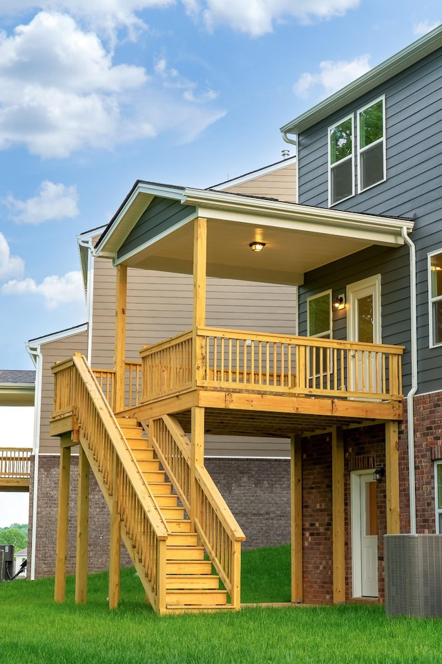 316 Deacon Ln, White House, TN 37188 - rear view of house featuring brick siding, stairs, central AC, and a lawn