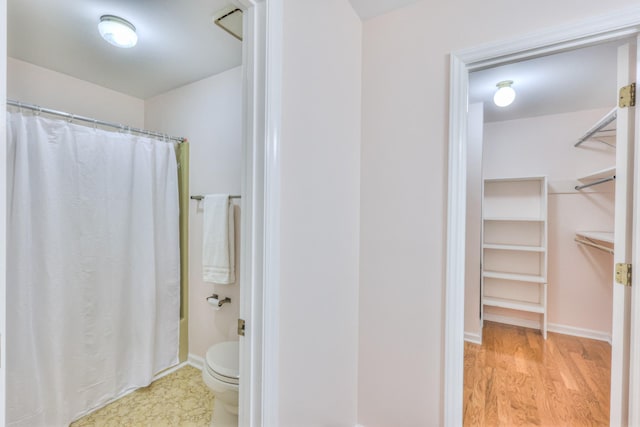 2519 Regency Park Dr, Murfreesboro, TN 37129 - full bath with toilet, a spacious closet, wood finished floors, and baseboards