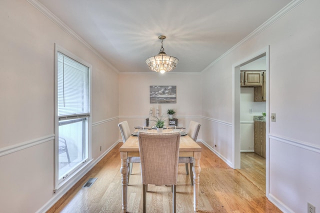 2519 Regency Park Dr, Murfreesboro, TN 37129 - dining area with light wood finished floors, crown molding, a chandelier, and baseboards