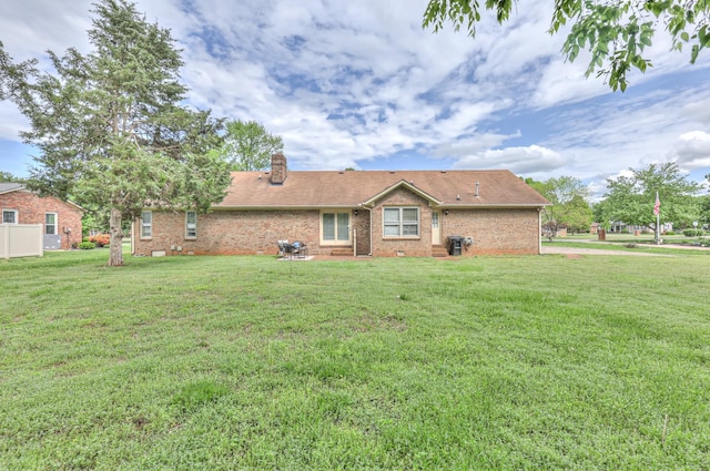 2519 Regency Park Dr, Murfreesboro, TN 37129 - rear view of house featuring a chimney, brick siding, and a yard
