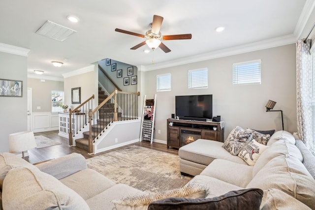 319 Petunia Dr, Smyrna, TN 37167 - living area with ornamental molding, wood finished floors, stairs, a ceiling fan, and a wainscoted wall