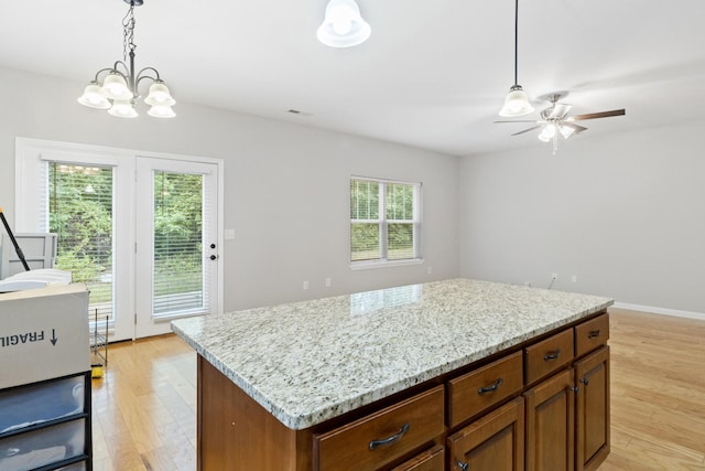 1190 Stonegate Cir NW, Cleveland, TN 37312 - kitchen featuring light wood-style flooring, decorative light fixtures, and brown cabinetry