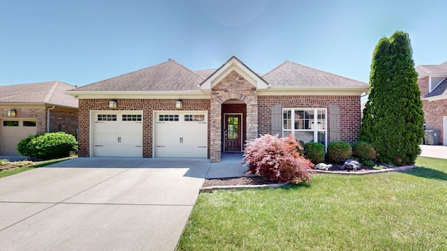4421 Janefield Way, Nolensville, TN 37135 - view of front of house featuring a garage, concrete driveway, roof with shingles, and brick siding