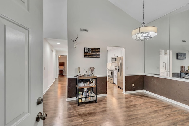 212 Post Creek Rd, Nashville, TN 37221 - dining room featuring high vaulted ceiling, wood finished floors, baseboards, and a chandelier
