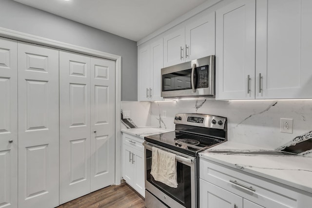 212 Post Creek Rd, Nashville, TN 37221 - kitchen featuring appliances with stainless steel finishes, white cabinetry, and light stone counters