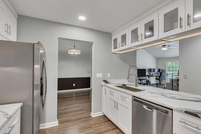 212 Post Creek Rd, Nashville, TN 37221 - kitchen featuring appliances with stainless steel finishes, a sink, ceiling fan, dark wood-style floors, and light stone counters