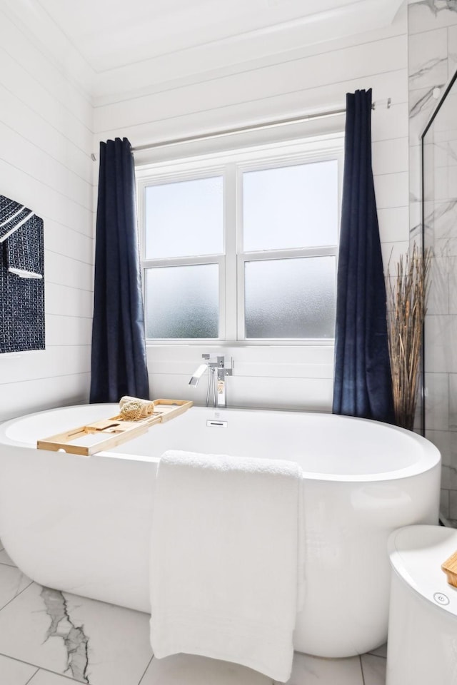 11769 Milton St, Milton, TN 37118 - bathroom featuring marble look tiles and a freestanding bath