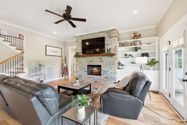 11769 Milton St, Milton, TN 37118 - living area with light wood-style floors, ceiling fan, crown molding, a stone fireplace, and stairway