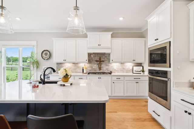 11769 Milton St, Milton, TN 37118 - kitchen featuring stainless steel appliances, light countertops, white cabinetry, ornamental molding, and recessed lighting