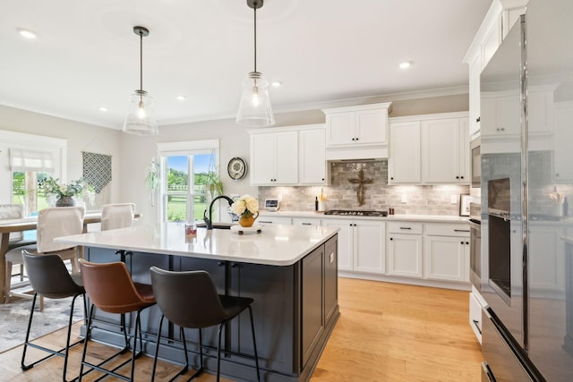 11769 Milton St, Milton, TN 37118 - kitchen with light countertops, decorative backsplash, a breakfast bar, white cabinets, and recessed lighting