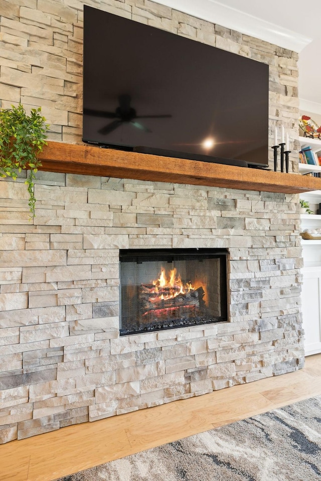 11769 Milton St, Milton, TN 37118 - detailed view of ceiling fan, a stone fireplace, and wood finished floors