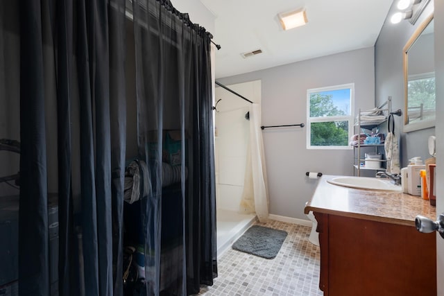 287 Rack Clayton Rd, Hohenwald, TN 38462 - bathroom featuring vanity, a stall shower, tile patterned flooring, and baseboards
