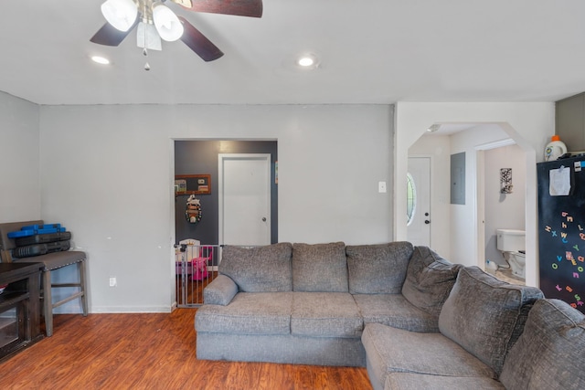 287 Rack Clayton Rd, Hohenwald, TN 38462 - living room featuring wood finished floors, ceiling fan, arched walkways, electric panel, and baseboards