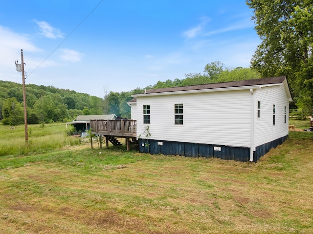 287 Rack Clayton Rd, Hohenwald, TN 38462 - back of property with a deck and a yard