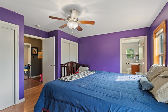 287 Rack Clayton Rd, Hohenwald, TN 38462 - bedroom with wood finished floors, baseboards, ceiling fan, and ensuite bath