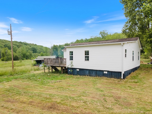 287 Rack Clayton Rd, Hohenwald, TN 38462 - rear view of house featuring a deck and a lawn
