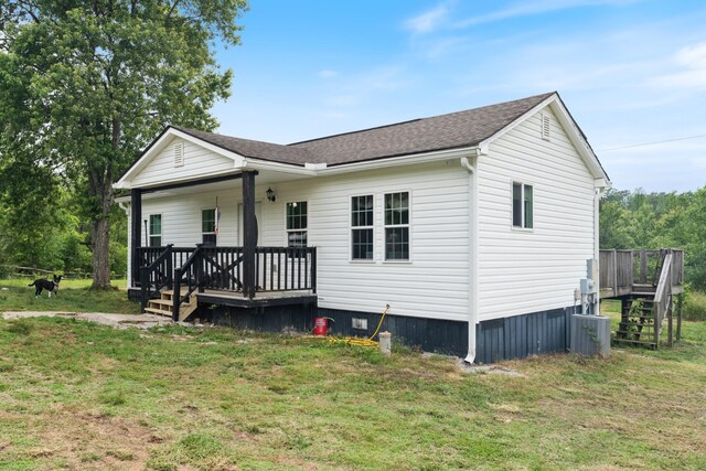 287 Rack Clayton Rd, Hohenwald, TN 38462 - view of front of property featuring stairs, a front lawn, a porch, a shingled roof, and central air condition unit