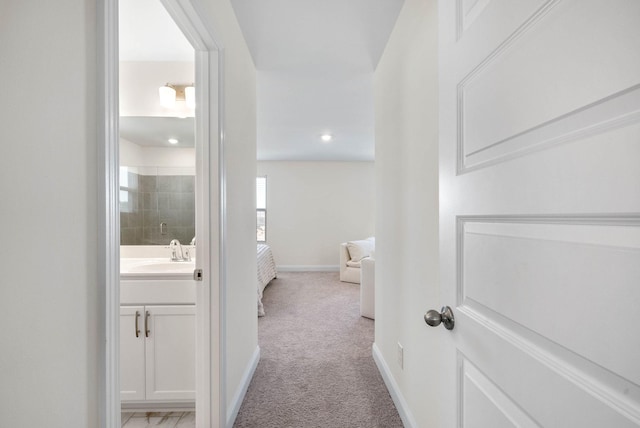 967 Nance Ln, Lebanon, TN 37087 - hall with light colored carpet, baseboards, and a sink