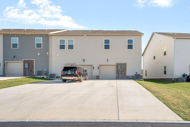 967 Nance Ln, Lebanon, TN 37087 - rear view of house with central air condition unit, concrete driveway, and a garage